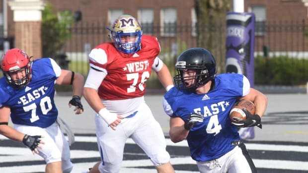 Salem's Jordan Turner (4) carries for the East in the Arkansas High School Coaches Association's All-Star football game Saturday night at Estes Stadium in Conway.
